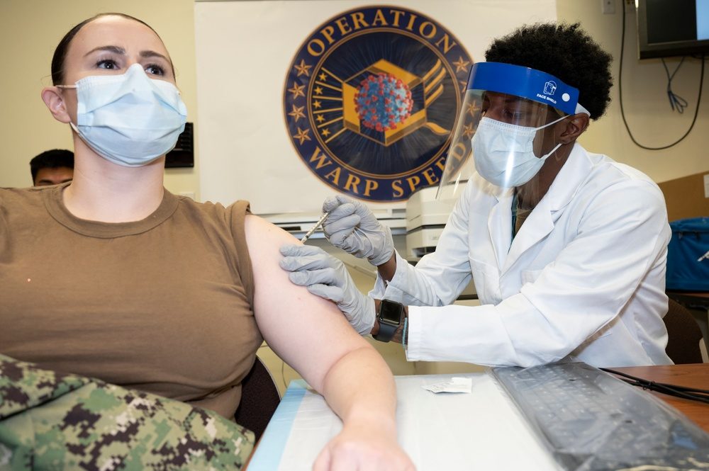 Medical staff are vaccinated at Walter Reed, December 2020.